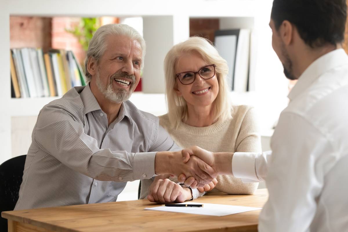 Late Life Planning Happy senior old family couple clients make financial insurance estate business deal handshake agent lawyer, satisfied mature customers shake hand